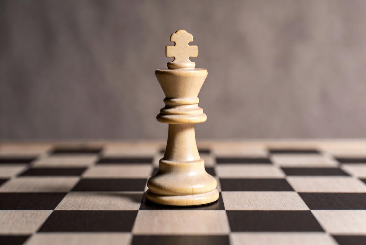 Alt text: Intense chess match culminates in awe-inspiring checkmate in dimly lit room.